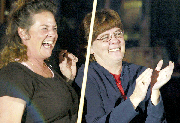 Keleigh Scheuermann, Lansing, left, and Lin Davis, Oak Grove, Mo.,
share a laugh as they wait their turns at the pool table. The women
said pool gives them a chance to get out of the house, work on
their skills and get to know other people.