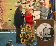 Kansas Gov. Kathleen Sebelius and her husband, Gary, accept a
framed drawing of the Kansas quarter design from David Lebryk,
acting director of the United States Mint. About 5,000 people
attended the quarter launch, held Friday morning at the Kansas
State Fair in Hutchinson. The coins went into circulation Friday.
Between 550 million and 650 million of the quarters will be minted,
half of which will be made at the Philadelphia mint and the other
half at the Denver mint.