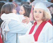 Roxie McGraw, the mother of new Tonganoxie High School graduate
Catherine McGraw, hugs Erin O'Brien after the ceremony. Also
pictured is Nina Nix.