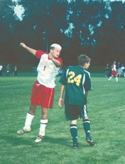 Tonganoxie's Brad Willis heads a ball against a Basehor-Linwood
player last week in Tonganoxie. THS shutout Basehor-Linwood, 5-0,
at Chieftain Park, but dropped a 10-2 decision to Lansing on Monday
in Lansing. The Chieftains are 4-6-1 heading into today's game
against Mill Valley in Tonganoxie.