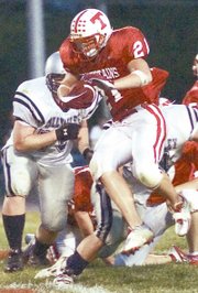 THS running back Zach Ditty goes airborne as he rushes against Mill
Valley on Friday in Tonganoxie. The Jags dropped THS, 21-14.