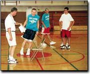 Mike Webb, Chieftain basketball coach, times Brett Cruickshank
while teammates look on during last weeks summer basketball camp.
The camps focus was on fundamentals, but the team did work on some
offensive and defense plays.