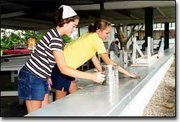Sunday afternoon, Valerie Gunn, left, and Justyne McCoy, along with
about 100 other volunteers met at the Leavenworth County
Fairgrounds to get everything ship-shape for this week's fair. Gunn
and McCoy are members of the Happy Helpers 4-H Club.