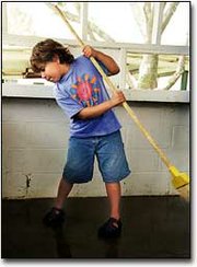 Sweeping the floor of the Happy Helpers food stand, Jennifer Rains
helped with Sunday's fairgrounds cleanup.