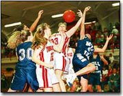 Tonganoxie's Alicia Stauch, front, and Kristin Korb, middle, battle
against Mill Valley girls for a rebound in the Chieftains' 44-26
victory against the Jaguars Friday night.