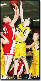 Tonganoxie's Scott Breuer, above, shoots over an Olathe Christian
player on Saturday during the Tonganoxie Invitational Basketball
Tournament.