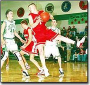Scott Breuer grabs a rebound while Bryan Gurss gets ready to head
to the other end in the boys' win against DeSoto Friday night. The
Chieftains beat the Wildcats 54-42 for their seventh win.