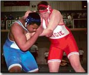 Senior Tony Miller battles Sumner Academy's Rhett Caviel in the
275-pound consolation final match in Holton.