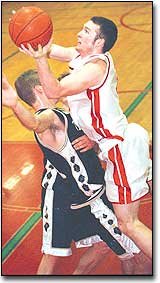 Kyle Rodell, THS senior, gets fouled on his way to the hoop in the
fourth quarter of Tonganoxie's Monday night first round, Sub-State
loss to Topeka Hayden. The Chieftains lost, 37-63.