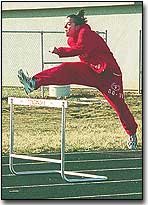 Aimee Eisman launches herself over a hurdle during Friday's
practice. Coaches expect Eisman to do well in the hurdles after
taking sixth in both the high and intermediates last year at the
league meet.