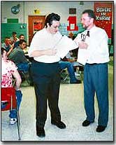 Jason McBroom, THS boys basketball manager, receives a
participation certificate from Coach Mike Webb at the team's March
13 banquet. McBroom also made the team's all-academic list.