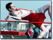 Chris Vernon clears the high jump bar at last Friday's Eudora
Invitational. The boys team finished second in team points, and the
girls team took first. So far, the girls have won their first three
meets, while the boys have won two of three.