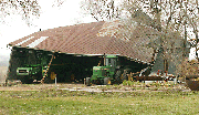 Sunday morning's severe weather damaged this barn at the home of
John and Carolyn Wise about six miles south of Tonganoxie on County
Road 1.