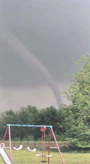 This photograph was made of Sunday's tornado. The view is looking
east from 190th Street, about one mile south of Evans Road.