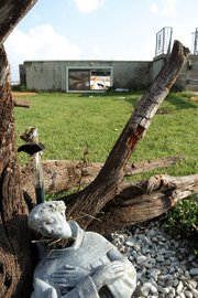 A garden statue of St. Francis of Assisi lies toppled before the
rubble of a tornado that swept through southeastern Leavenworth
County at about 4 p.m. Sunday.
